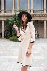 a lady in beige fitted double-breasted v-neck mini dress